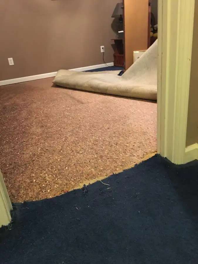 Carpet pad removal revealing water damage during Water Mitigation Services in Casper